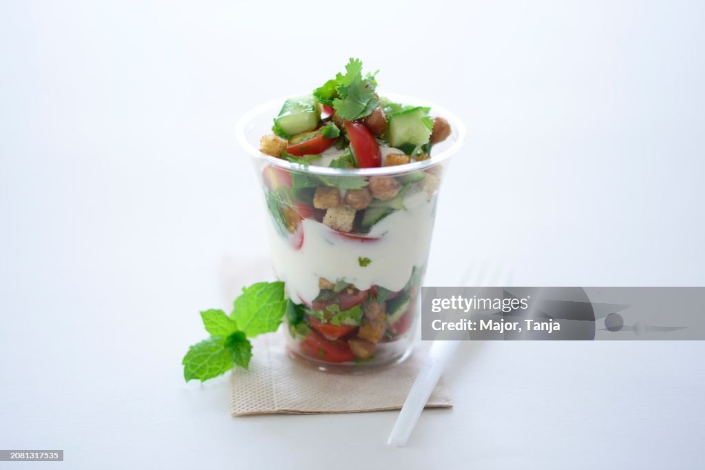 Garden salad with croutons and a yoghurt dressing in a takeaway cup