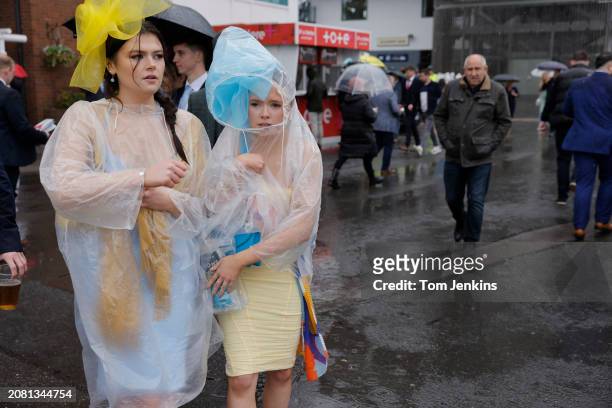 Cold and wet racegoers during racing on day two, Ladies Day, of the Grand National jump racing festival at Aintree Racecourse on April 14th 2023 in...