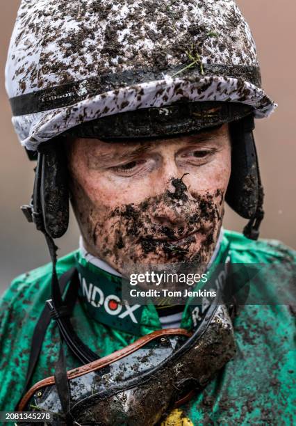 Jockey Sam Twiston-Davies walks back to the weighing room after finishing unplaced on Weveallbeencaught in the Sefton Novices Hurdle race during...