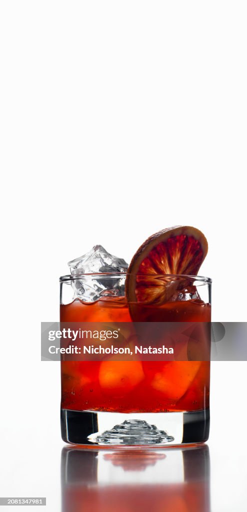 Red cocktail with garnish of a blood orange slice