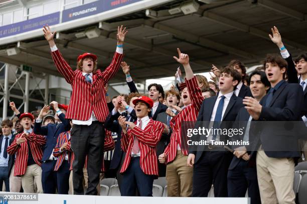 Eton College schoolboys cheering on their team during the Eton v Harrow cricket match at Lords Cricket Ground on May 12th 2023 in London, England