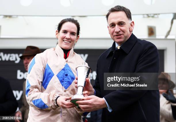 Trainer Henry De Bromhead and Rachael Blackmore pose with the trophy after winning the Betway Queen Mother Champion Chase on board Captain Guinness...