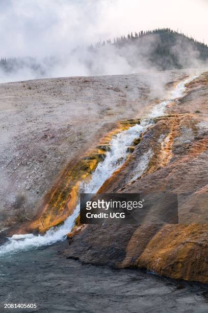 Run-off water from geysers and springs flows into the Firehole River in the Midway Geyser basin area of Yellowstone National Park.