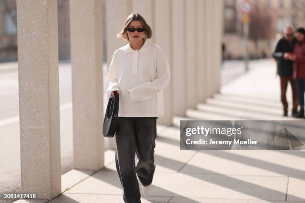 Sophia Geiss seen wearing YSL black sunglasses, COS white cotton buttoned polo sweater, Drykorn grey baggy wide leg denim pants / jeans, Coperni...