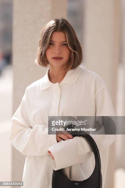 Sophia Geiss seen wearing YSL black sunglasses, COS white cotton buttoned polo sweater and Coperni black leather bag, on March 13, 2024 in Berlin,...