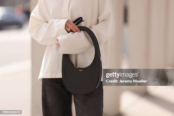 Sophia Geiss, bag detail, seen wearing YSL black sunglasses, COS white cotton buttoned polo sweater, Drykorn grey baggy wide leg denim pants / jeans...