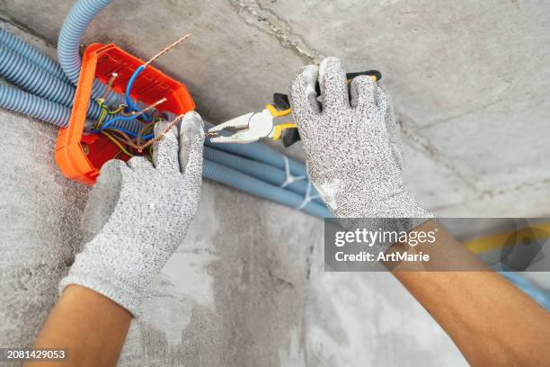 electrician working at a construction site during home or apartment renovation, repair or reconstruction - power cable stock pictures, royalty-free photos & images