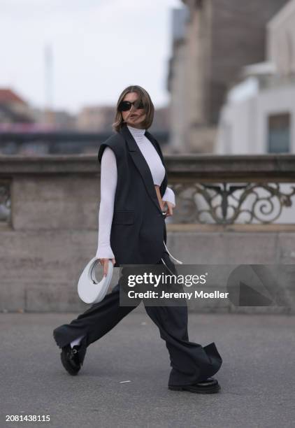 Sophia Geiss seen wearing Mango black sunglasses, Intimissimi white cashmere cropped sheer high neck top, Herskind dark grey suit vest, matching...