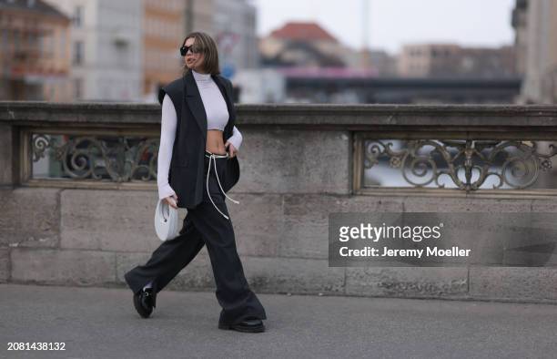Sophia Geiss seen wearing Mango black sunglasses, Intimissimi white cashmere cropped sheer high neck top, Herskind dark grey suit vest, matching...