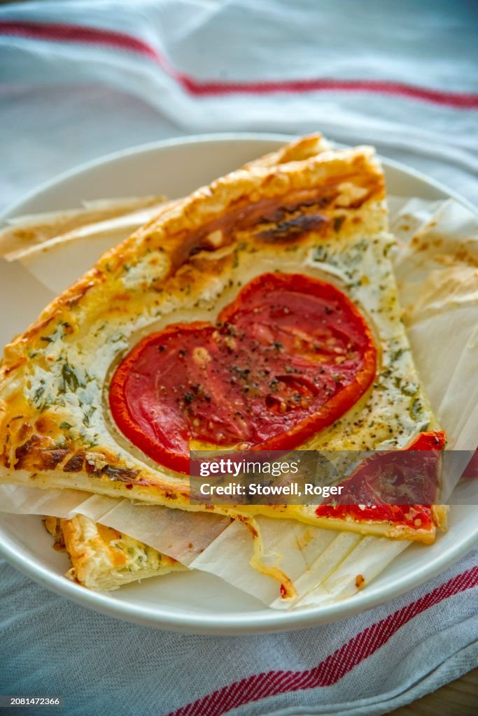 Slices of cheese tart with tomato