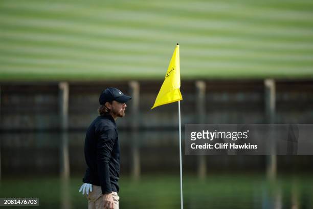 Tommy Fleetwood of England looks on from the 17th green during a practice round prior to THE PLAYERS Championship on the Stadium Course at TPC...