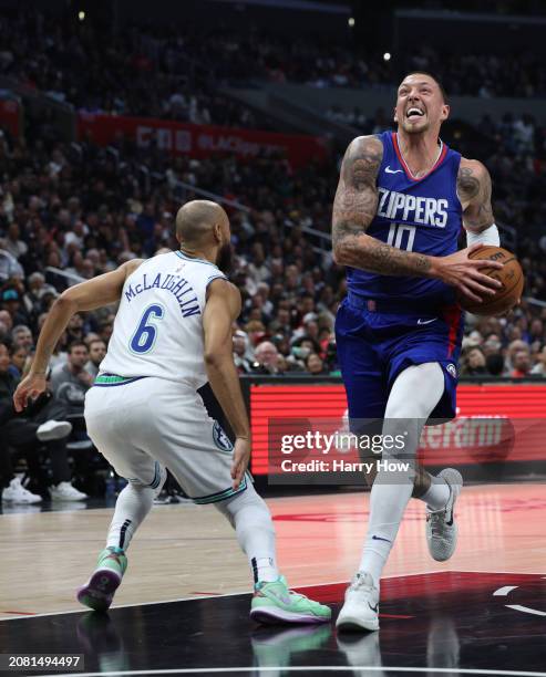 Daniel Theis of the LA Clippers drives to the basket on Jordan McLaughlin of the Minnesota Timberwolves during a 118-100 Timberwolves win at...