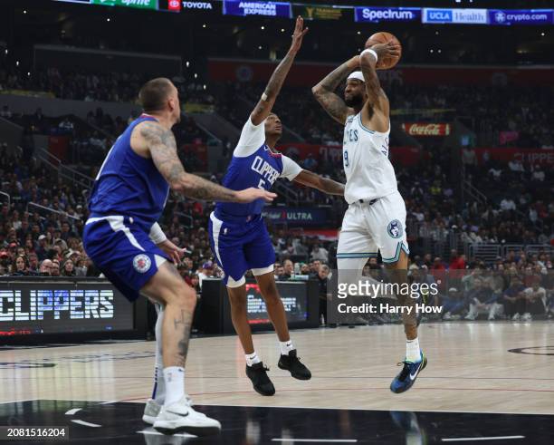 Nickeil Alexander-Walker of the Minnesota Timberwolves looks to pass in front of Bones Hyland and Daniel Theis of the LA Clippers during a 118-100...