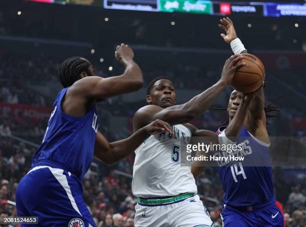 Anthony Edwards of the Minnesota Timberwolves drives to the basket between Terance Mann and Kawhi Leonard of the LA Clippers during a 118-100...