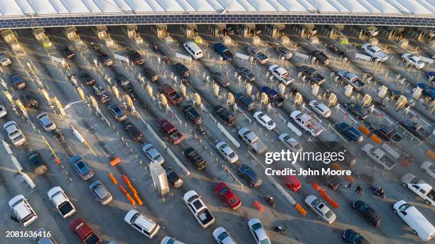 In an aerial view, morning commuter traffic waits to cross into the United States from Tijuana, Mexico on March 6, 2024 in San Ysidro, California....