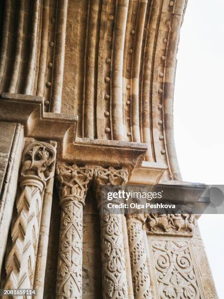 close-up of ornate stone columns with intricate carvings, showcasing the artistry of historical architectural design - vintage embellishment stock pictures, royalty-free photos & images