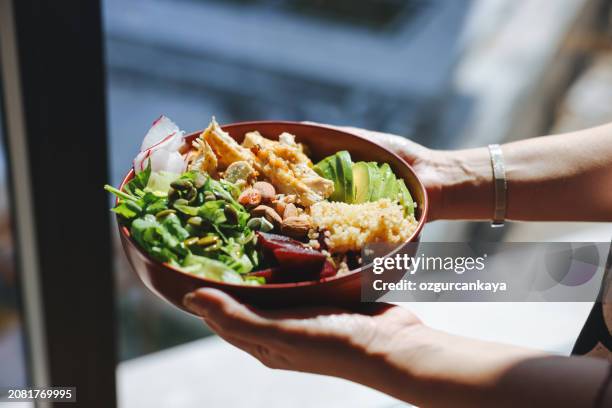 holding a bowl of chicken salad - meal stock pictures, royalty-free photos & images