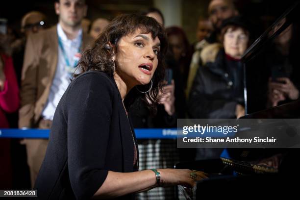 Norah Jones performs on Elton John's Piano at King's Cross St. Pancras Station on March 13, 2024 in London, England.