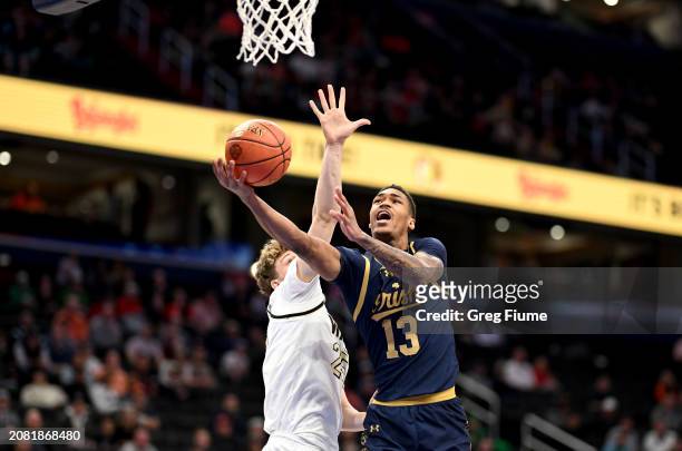 Tae Davis of the Notre Dame Fighting Irish drives to the basket in the second half against Matt Zona of the Notre Dame Fighting Irish in the Second...