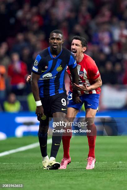 Stefan Savic of Atletico de Madrid battles for the ball with Marcus Thuram FC Internazionale during the UEFA Champions League 2023/24 round of 16...