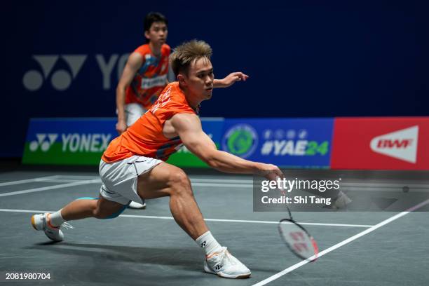 Man Wei Chong and Kai Wun Tee of Malaysia compete in the Men's Doubles first Round match against Akira Koga and Taichi Saito of Japan during day two...