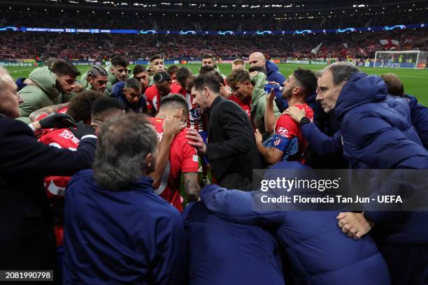 Diego Simeone, Head Coach of Atletico Madrid, leads a team talk as the players and coaching staff of FC Internazionale form a huddle at half-time...