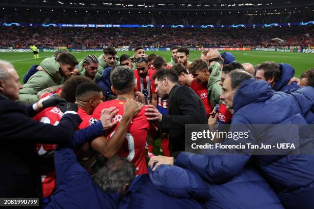 Diego Simeone, Head Coach of Atletico Madrid, leads a team talk as the players and coaching staff of FC Internazionale form a huddle at half-time...