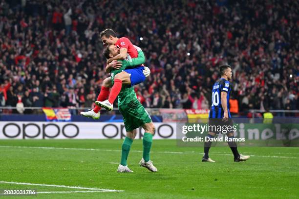 Jan Oblak and Cesar Azpilicueta of Atletico Madrid celebrate following the team's victory in the penalty shoot out during the UEFA Champions League...