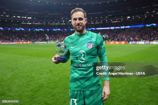 Jan Oblak of Atletico Madrid poses for a photo with the PlayStation Player Of The Match award after the team's victory in the penalty shoot out...