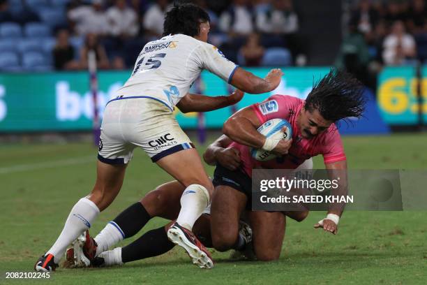 Waratahs' Charlie Gamble is tackled during the Super Rugby match between the NSW Waratahs and the Blues in Sydney on March 16, 2024. / -- IMAGE...