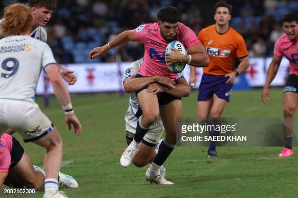 Waratahs' Triston Reilly is tackled during the Super Rugby match between the NSW Waratahs and the Blues in Sydney on March 16, 2024. / -- IMAGE...