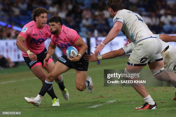 Waratahs' Triston Reilly avoids a tackle during the Super Rugby match between the NSW Waratahs and the Blues in Sydney on March 16, 2024. / -- IMAGE...