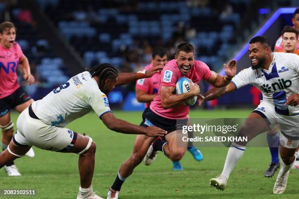 Blues' Hoskins Sotutu and Soane Vikena tackle Waratahs' Jake Gordon during the Super Rugby match between the NSW Waratahs and the Blues in Sydney on...