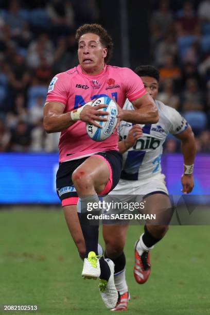 Waratahs' Mark Nawaqanitawase runs the ball during the Super Rugby match between the NSW Waratahs and the Blues in Sydney on March 16, 2024. / --...