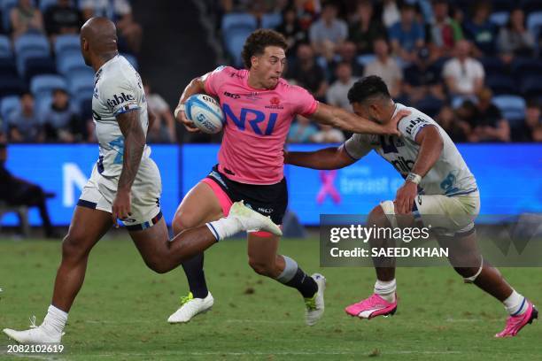 Waratahs' Mark Nawaqanitawase avoids a tackle by Blues' Akira Ioane during the Super Rugby match between the NSW Waratahs and the Blues in Sydney on...