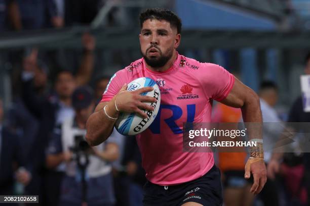 Waratahs' Triston Reilly runs the ball during the Super Rugby match between the NSW Waratahs and the Blues in Sydney on March 16, 2024. / -- IMAGE...