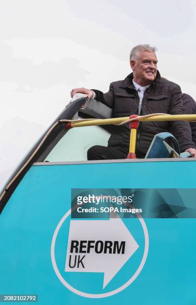 Lee Anderson sits on top of the open-top Reform UK battle bus with a Reform UK logo so he can travel around the Ashfield constituency during the...