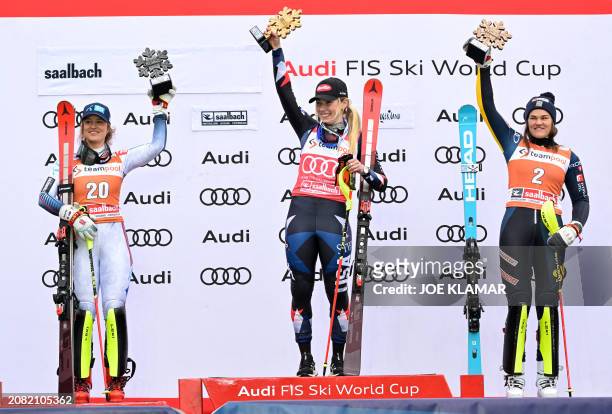 Second placed Norway's Mina Fuerst Holtmann, winner USA's Mikaela Shiffrin and third placed Sweden's Anna Swenn-Larsson celebrate on the podium of...