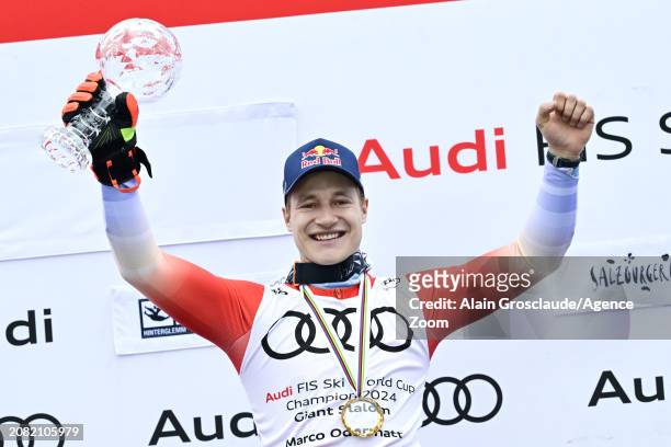 Marco Odermatt of Team Switzerland wins the globe in the overall standings during the Audi FIS Alpine Ski World Cup Finals Men's Giant Slalom on...