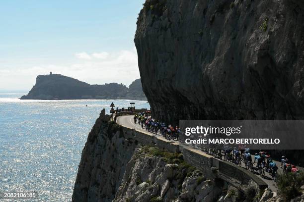 The pack rides along Capo Noli during the 115th Milan-SanRemo one-day classic cycling race, between Pavia and SanRemo, on March 16, 2024.