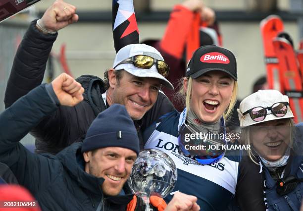 Slalom Overall World Cup 2024 winner USA's Mikaela Shiffrin celebrates with teammates after the women's Slalom event of FIS Ski Alpine World Cup in...