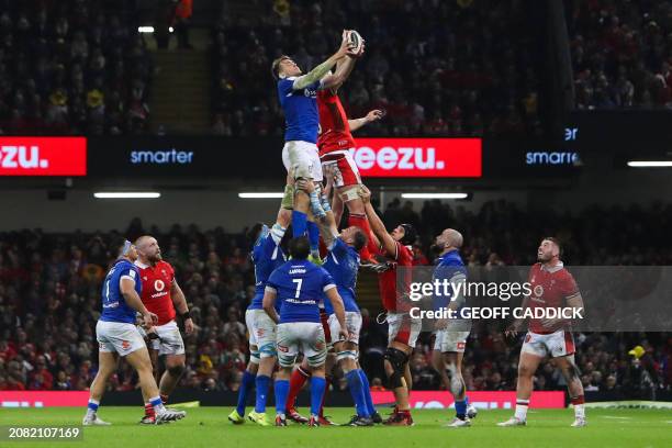 Italy's lock Federico Ruzza fights for the ball in a line out with Wales' number 8 Aaron Wainwright during the Six Nations international rugby union...