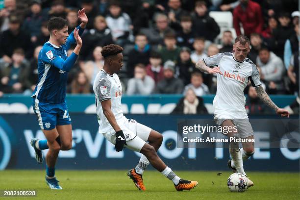 Jamal Lowe of Swansea City passes the ball to Josh Tymon during the Sky Bet Championship match between Swansea City and Cardiff City at the...