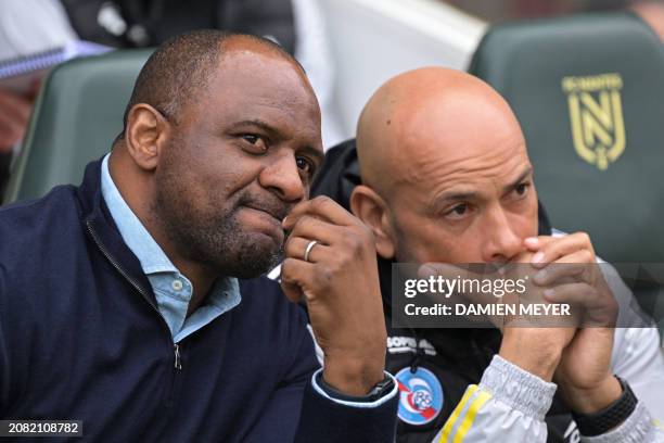 Strasbourg's French head coach Patrick Vieira talks with assistant coach Paul Nevis in the technical area during the French L1 football match between...