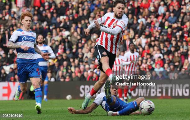 Adil Aouchiche of Sunderland is tackled as he takes his shot during the Sky Bet Championship match between Sunderland and Queens Park Rangers at...