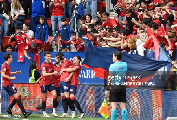 Osasuna's Croatian forward Ante Budimir celebrates scoring an equalizing goal during the Spanish league football match between CA Osasuna and Real...