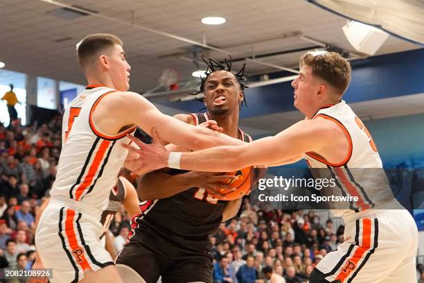 Princeton Tigers Guard Jack Scott and Brown Bears Forward Kalu Anya and Princeton Tigers Forward Caden Pierce battle for the ball during the first...