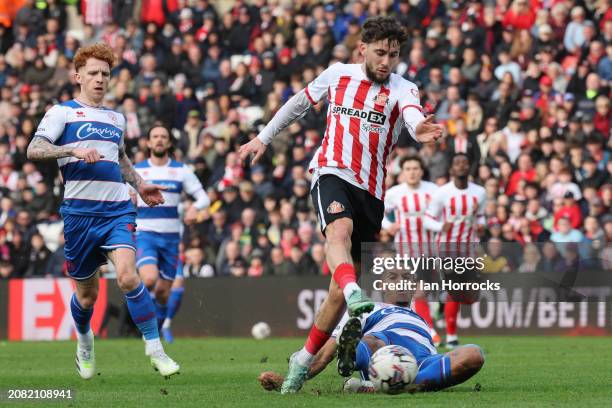 Adil Aouchiche of Sunderland is tackled as he takes his shot during the Sky Bet Championship match between Sunderland and Queens Park Rangers at...