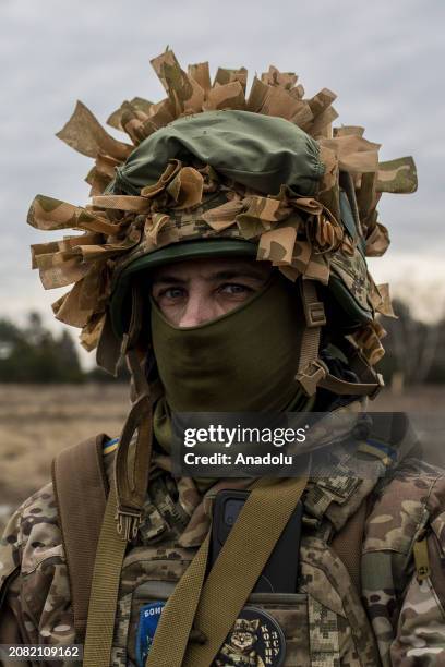 Member of 120th Independent Brigade of the Territorial Defense Forces of Ukraine takes part in training exercises as he wears camouflage near the...