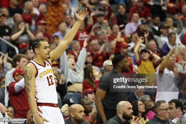 Iowa State Cyclones forward Robert Jones holds up three fingers to celebrate a teammates basket in the second half of a Big 12 tournament semifinal...